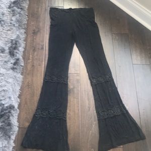 Black distressed flared pant with lace detail.